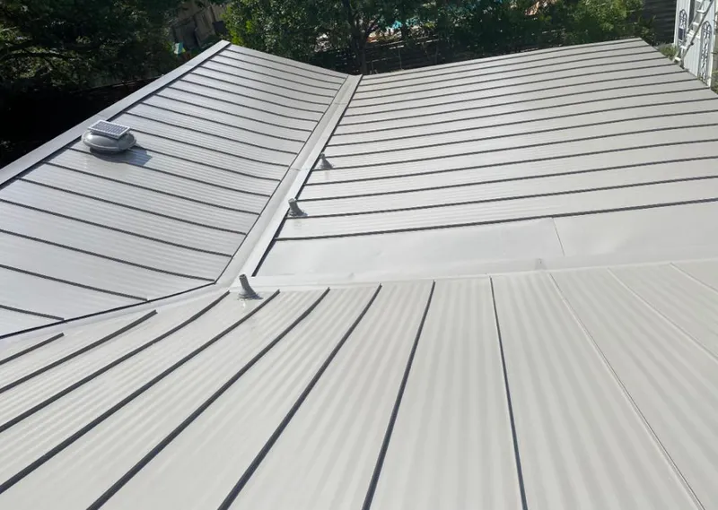 Solar attic fan installed on a metal roof for Roof Ventilation in Buda